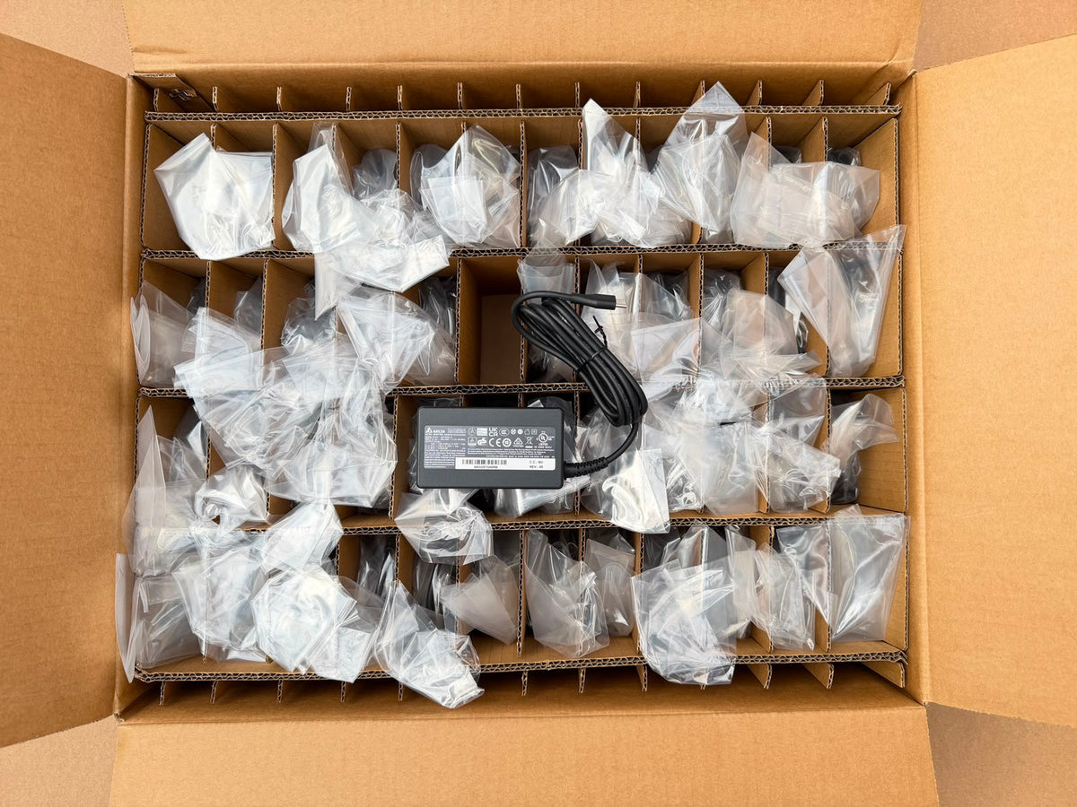 Trade box of 50 Delta 65W USB Type-C adapters, individually bagged in dividers